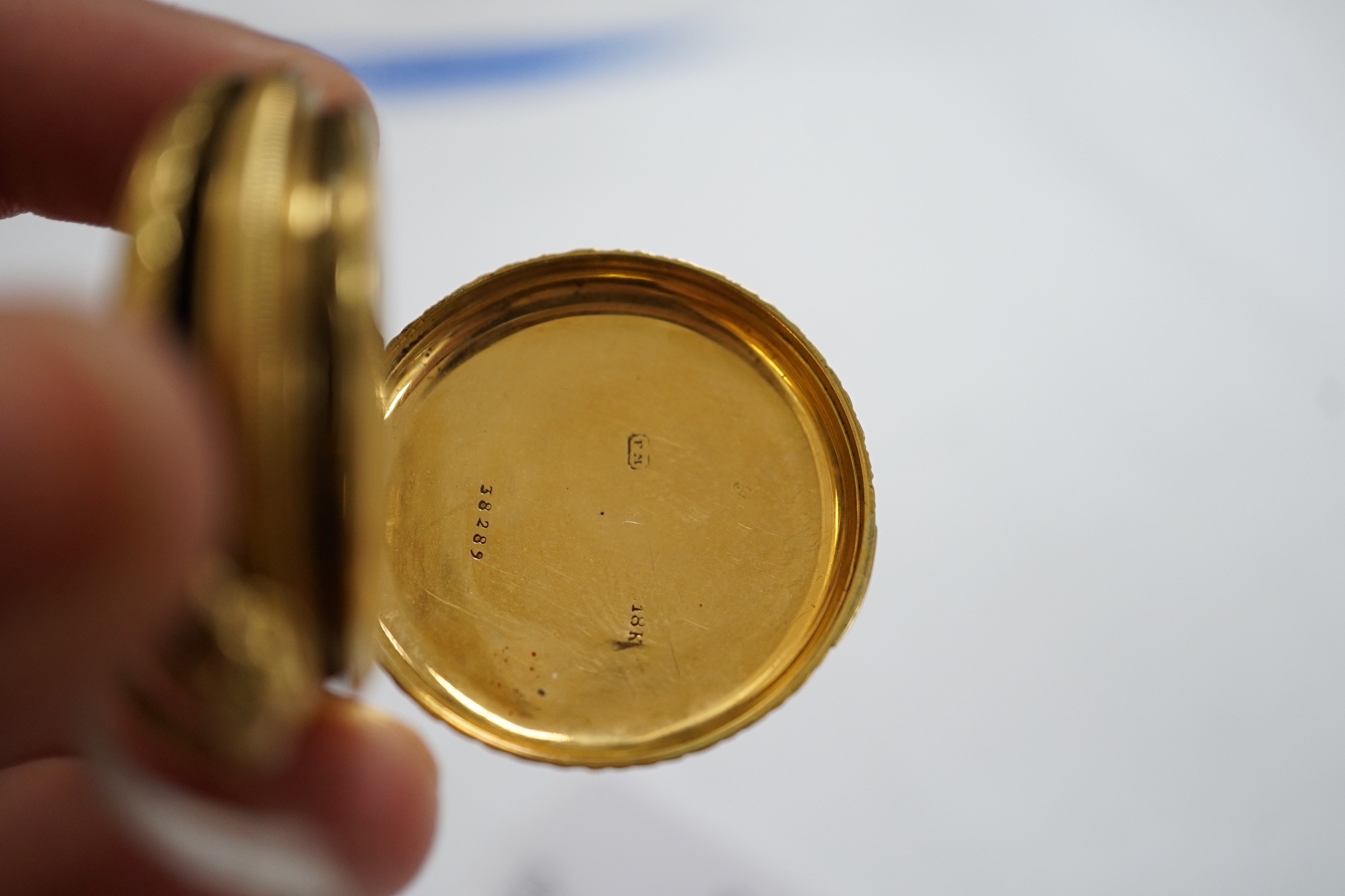 An early 20th century Swiss 18k and enamelled fob watch, decorated with the bust of a young girl and flowers verso, case diameter 33mm, gross weight 27.3 grams.